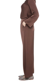Woman wearing a brown satin set outfit on a white background