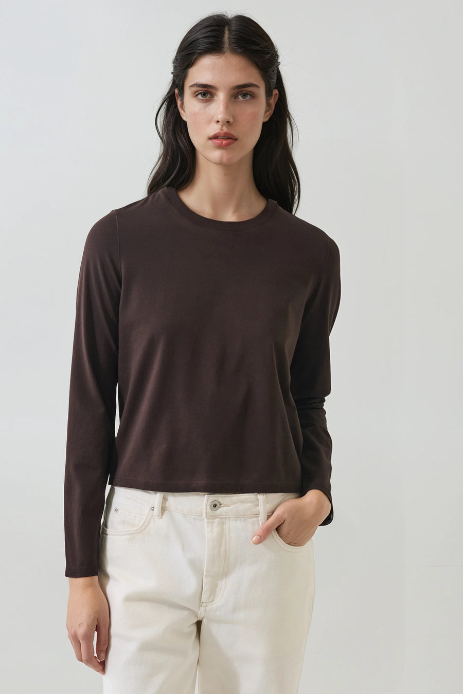 model wearing fitted dark brown long sleeve shirt with a relaxed fit 