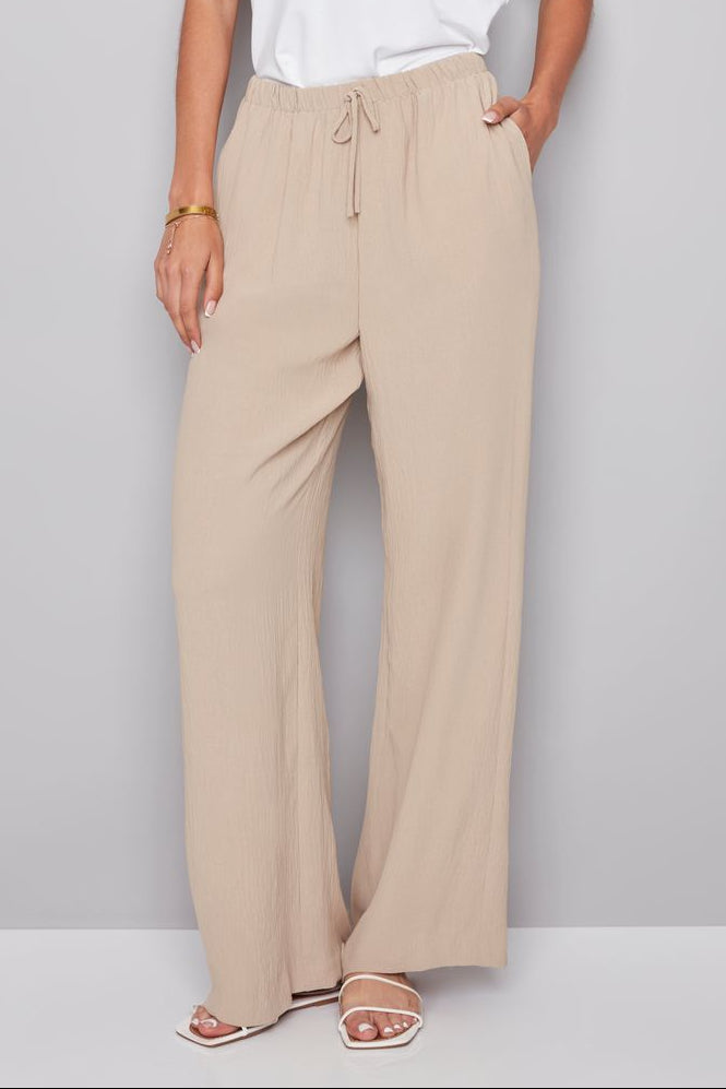 woman wearing a beige drawstring pant