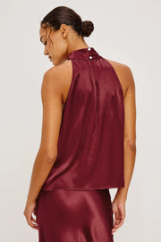 woman wearing a garnet halter top