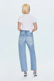Person wearing light blue jeans and a white shirt on a white background