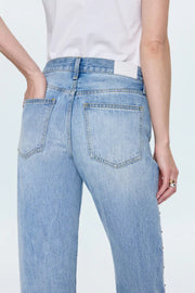Light blue jeans worn by a person on a white background
