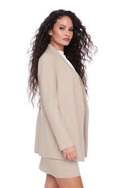 side view of woman using a beige neutral stretch collarless ponte blazer