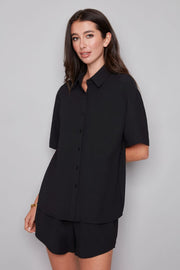 Woman wearing a black shirt and shorts set 