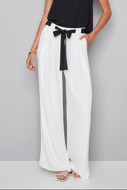 woman wearing a white pant with white shash belt 