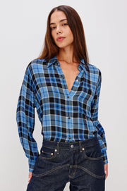 woman wearing blue plaid button up