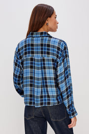 woman wearing blue plaid button up