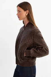 woman wearing brown basket weave jacket 