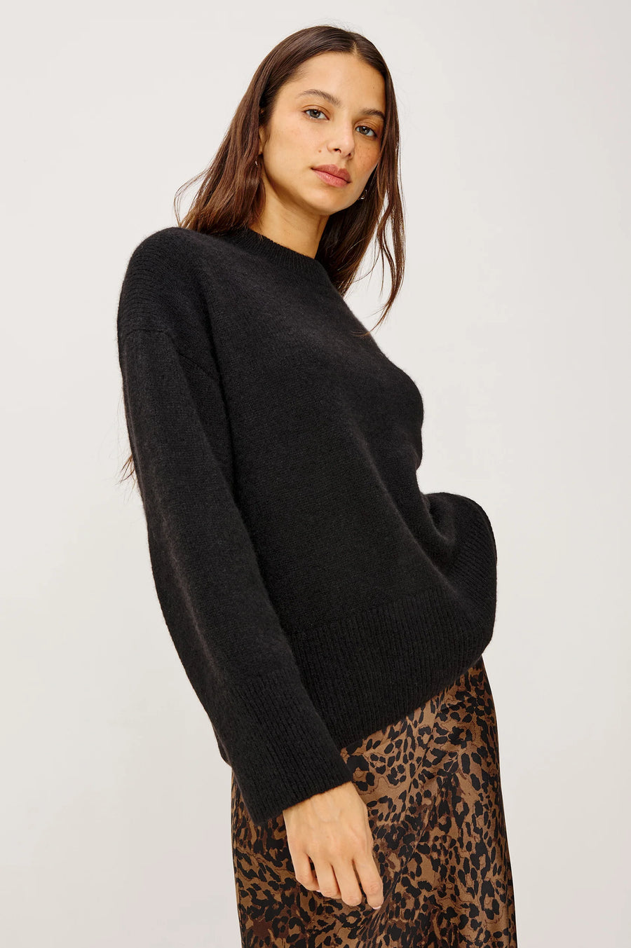 side view of a woman wearing a black cashmere blend sweater