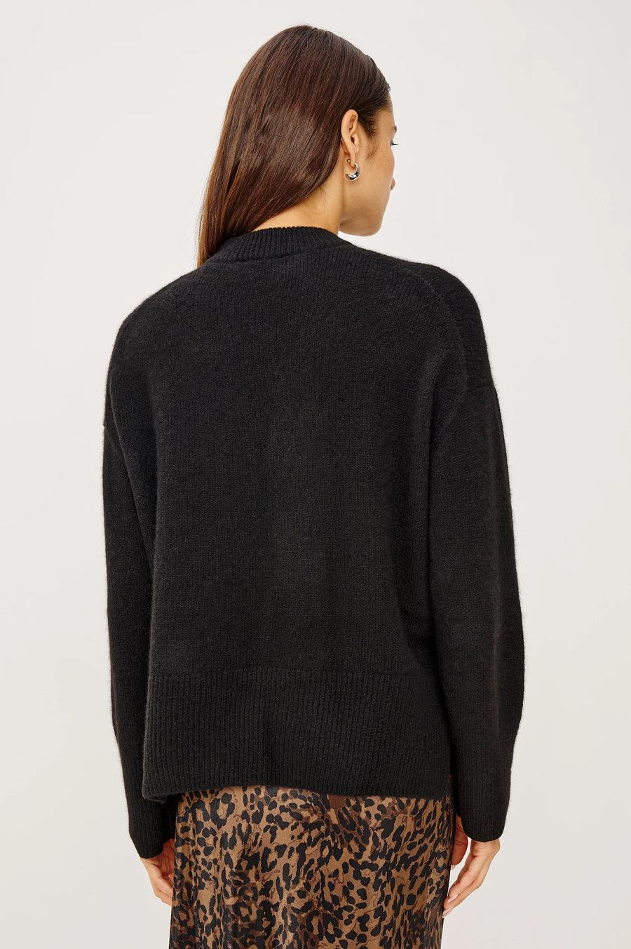 back view of woman wearing a black cashmere blend sweater