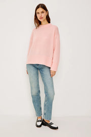 woman wearing a pink cash-blend sweater with jeans