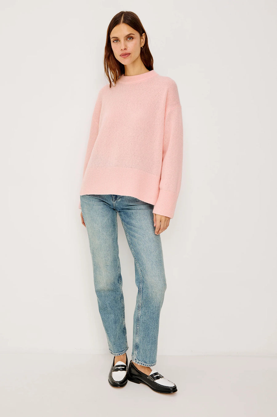 woman wearing a pink cash-blend sweater with jeans