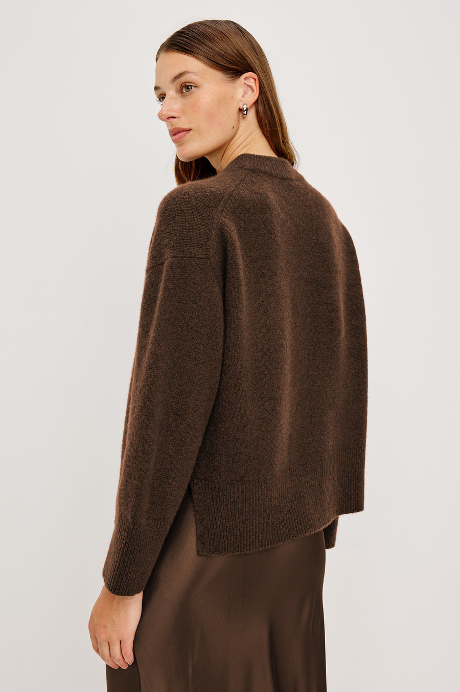 Back view of woman wearing an oversized cashmere brown sweater
