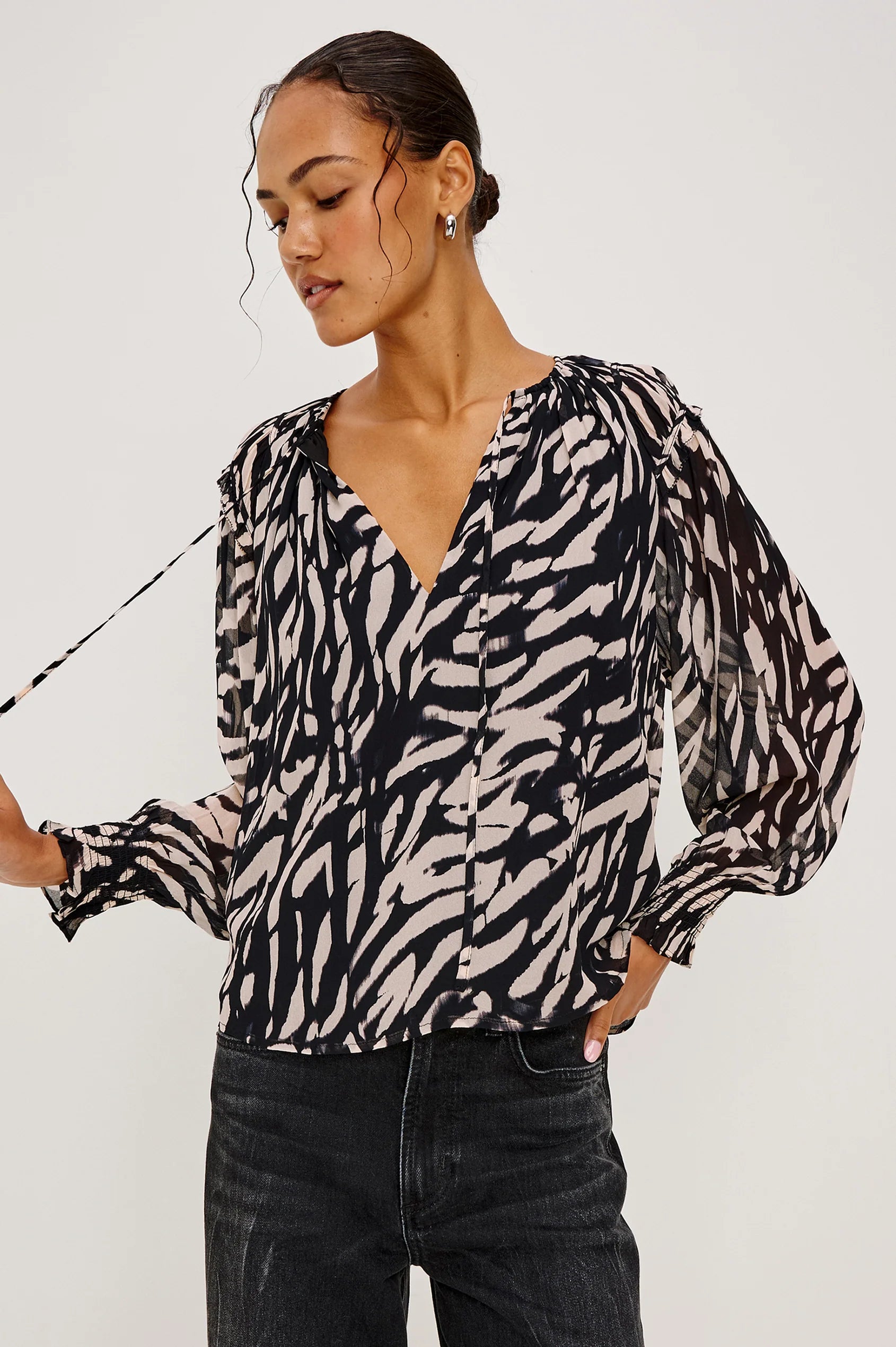 woman wearing a tiger stripped patterned blouse
