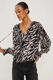 woman wearing a tiger stripped patterned blouse