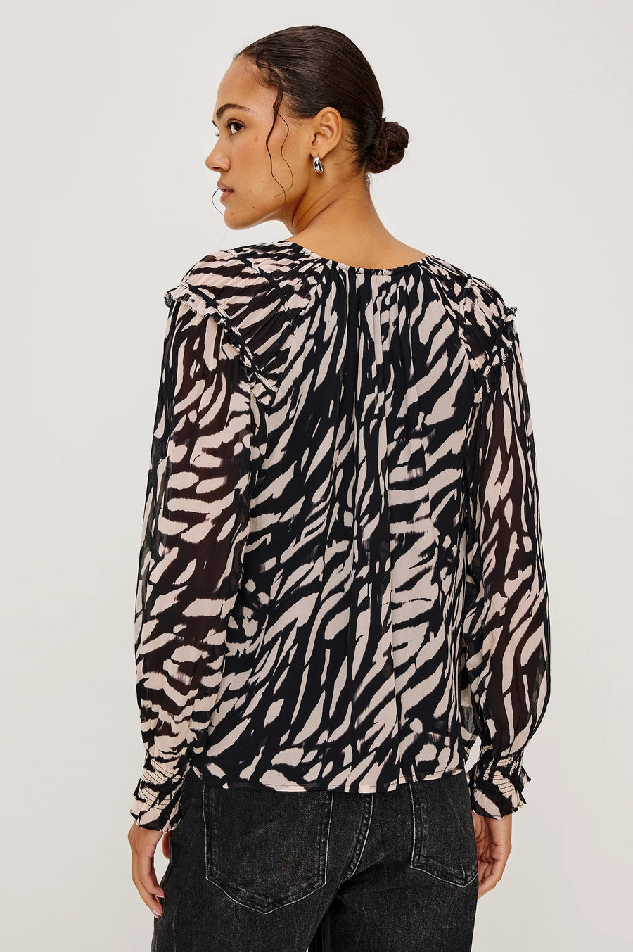 woman wearing a tiger stripped patterned blouse
