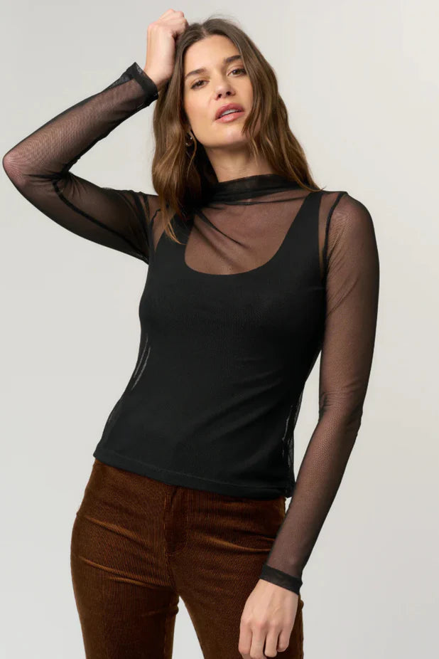 woman wearing a black mesh long sleeve with a tank top underneath