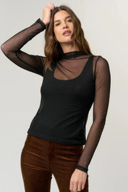 woman wearing a black mesh long sleeve with a tank top underneath
