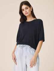 Woman wearing a navy short sleeved sweater