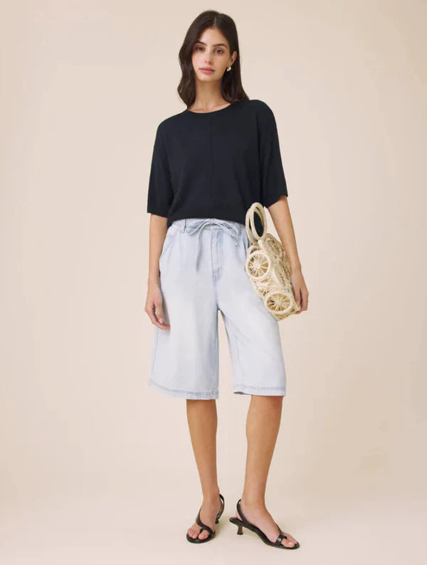 Woman wearing a navy short sleeved sweater