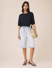 Woman wearing a navy short sleeved sweater