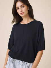 Woman wearing a navy short sleeved sweater