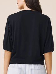 Woman wearing a navy short sleeved sweater