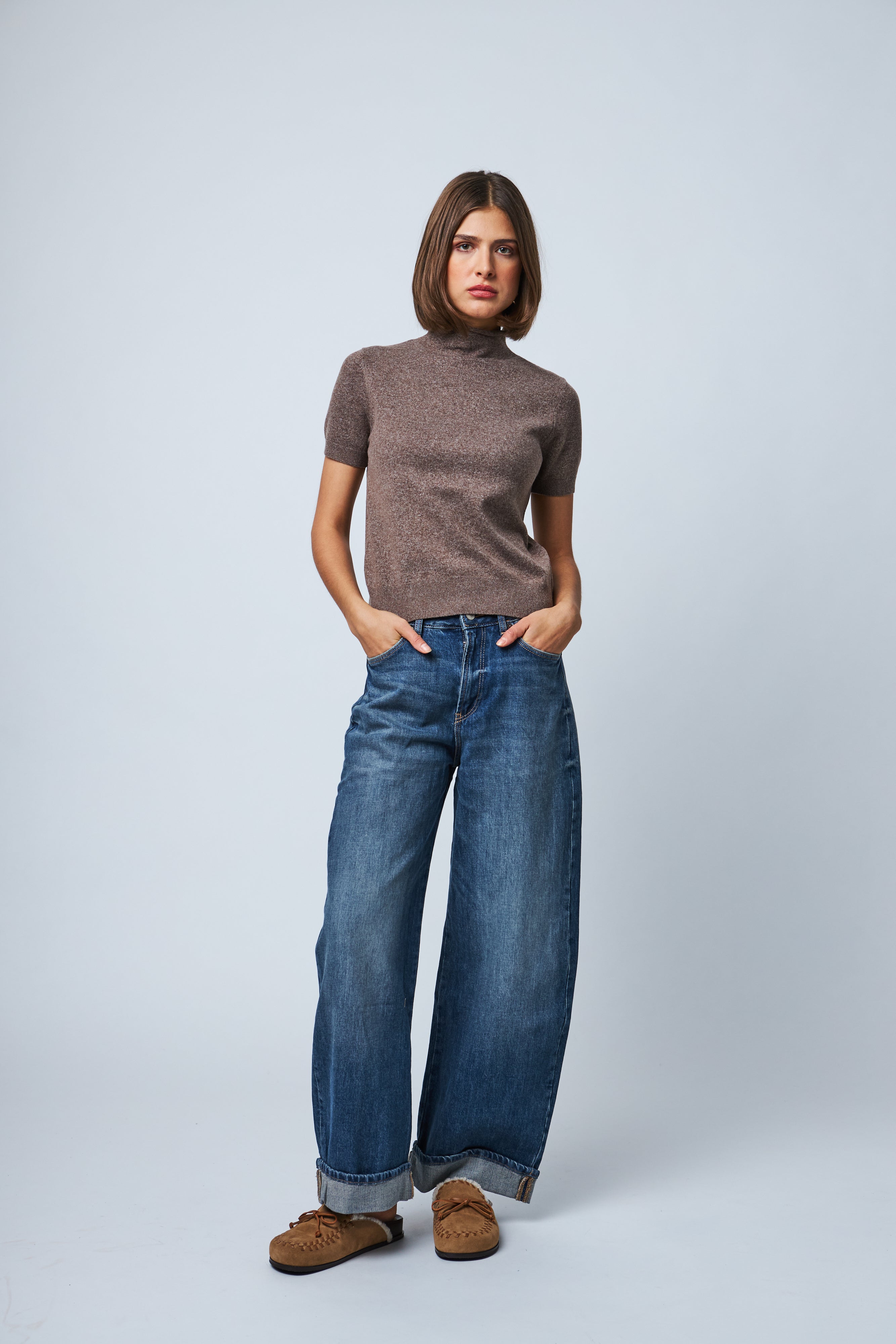 model wearing a fitted brown ribbed mock neck short sleeve knit top 