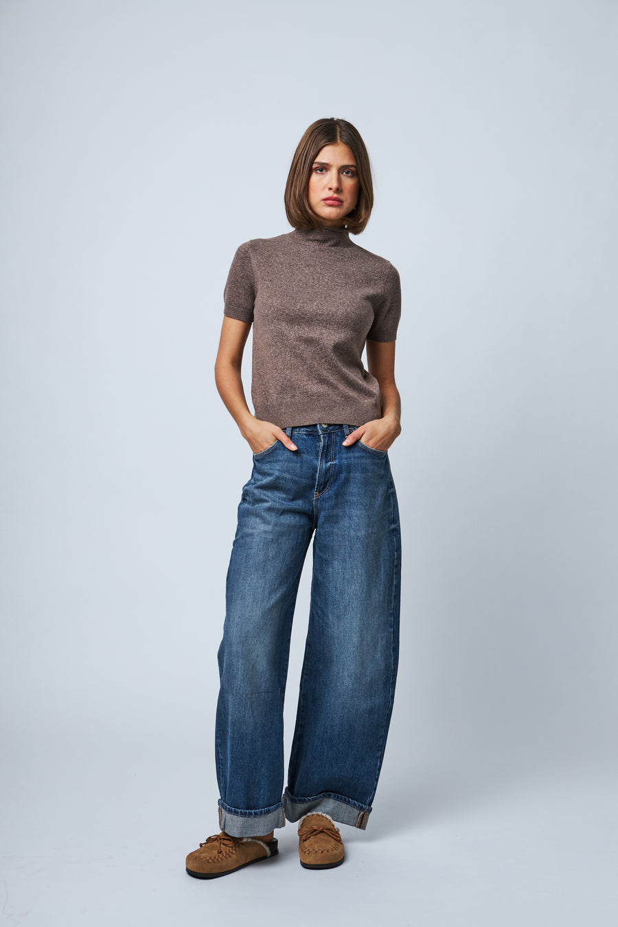 model wearing a fitted brown ribbed mock neck short sleeve knit top 