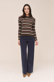 Woman wearing a striped sweater  on a beige background
