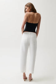 Woman wearing mid-rise white jeans with cuffed hem