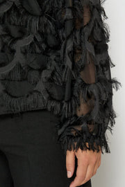 Black fringed garment on a plain background