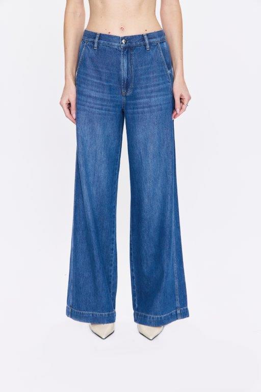 Blue jeans worn by a person on a white background