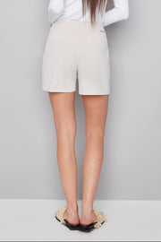 Woman wearing beige shorts with subtle stripes