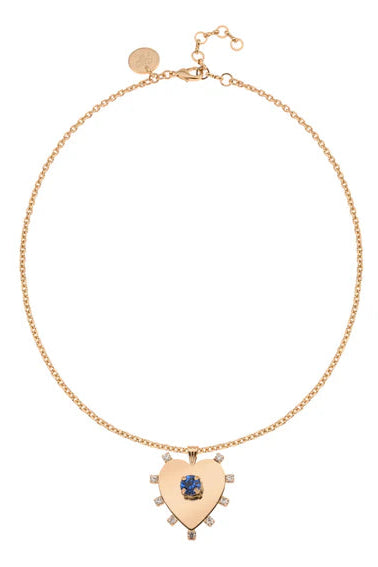 Gold necklace with a heart-shaped pendant on a white background