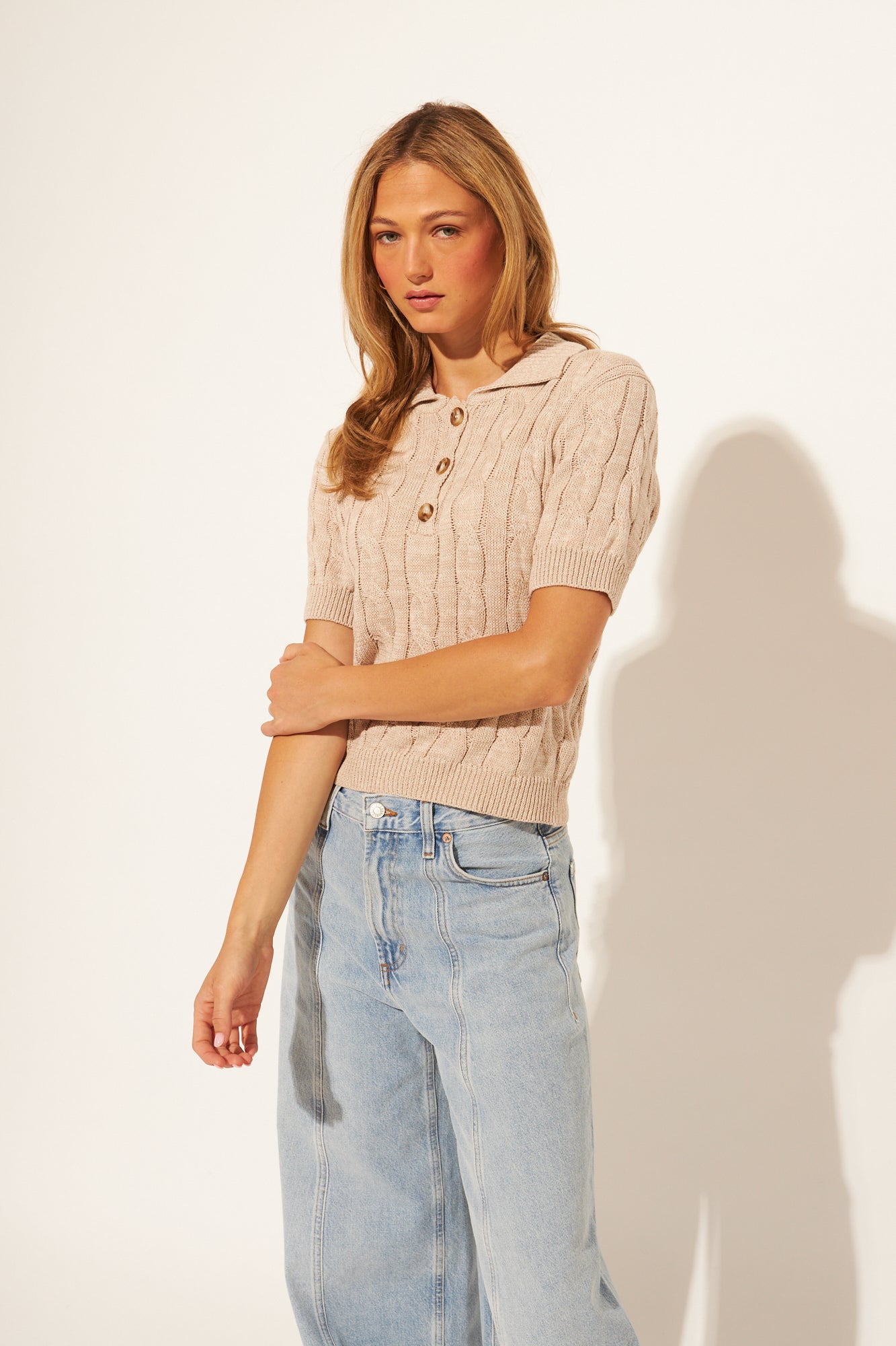 woman wearing a ribbed knit polo top