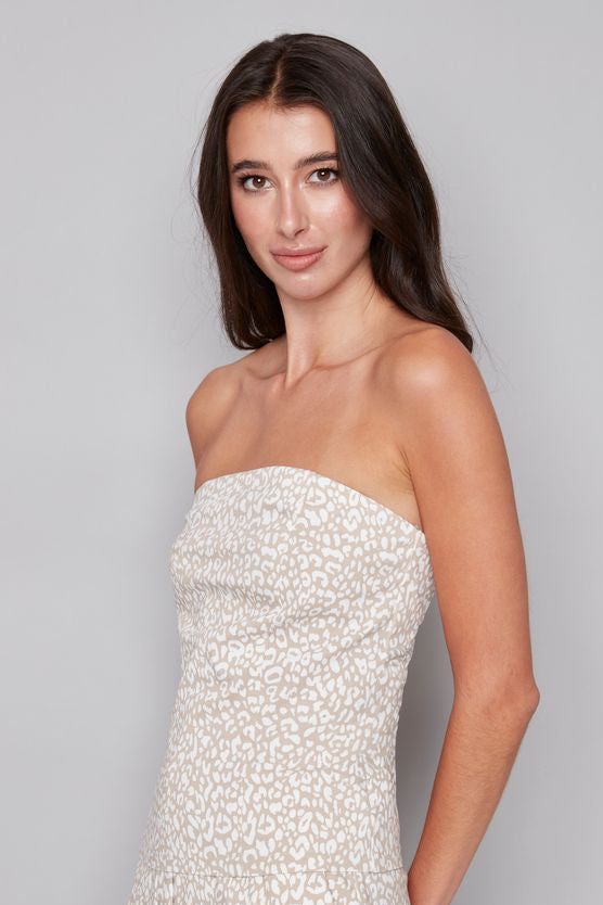 Woman wearing a strapless white and beige leopard print top