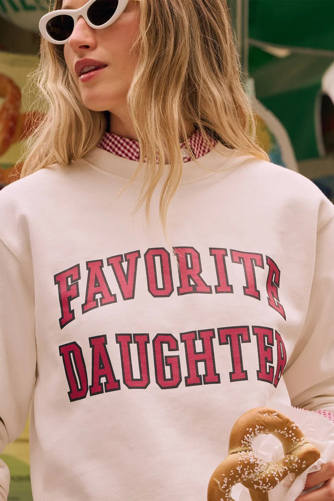 women wearing light pink crewneck sweatshirt with favorite daughter written in hot pink letters 