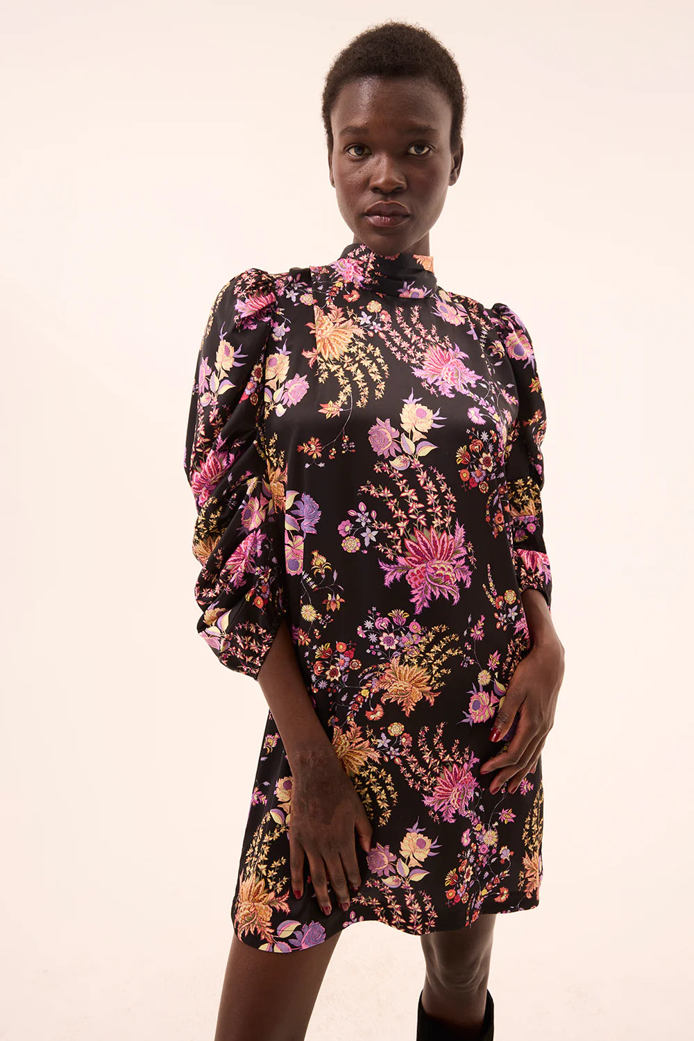 Model wearing a floral dress with a black background