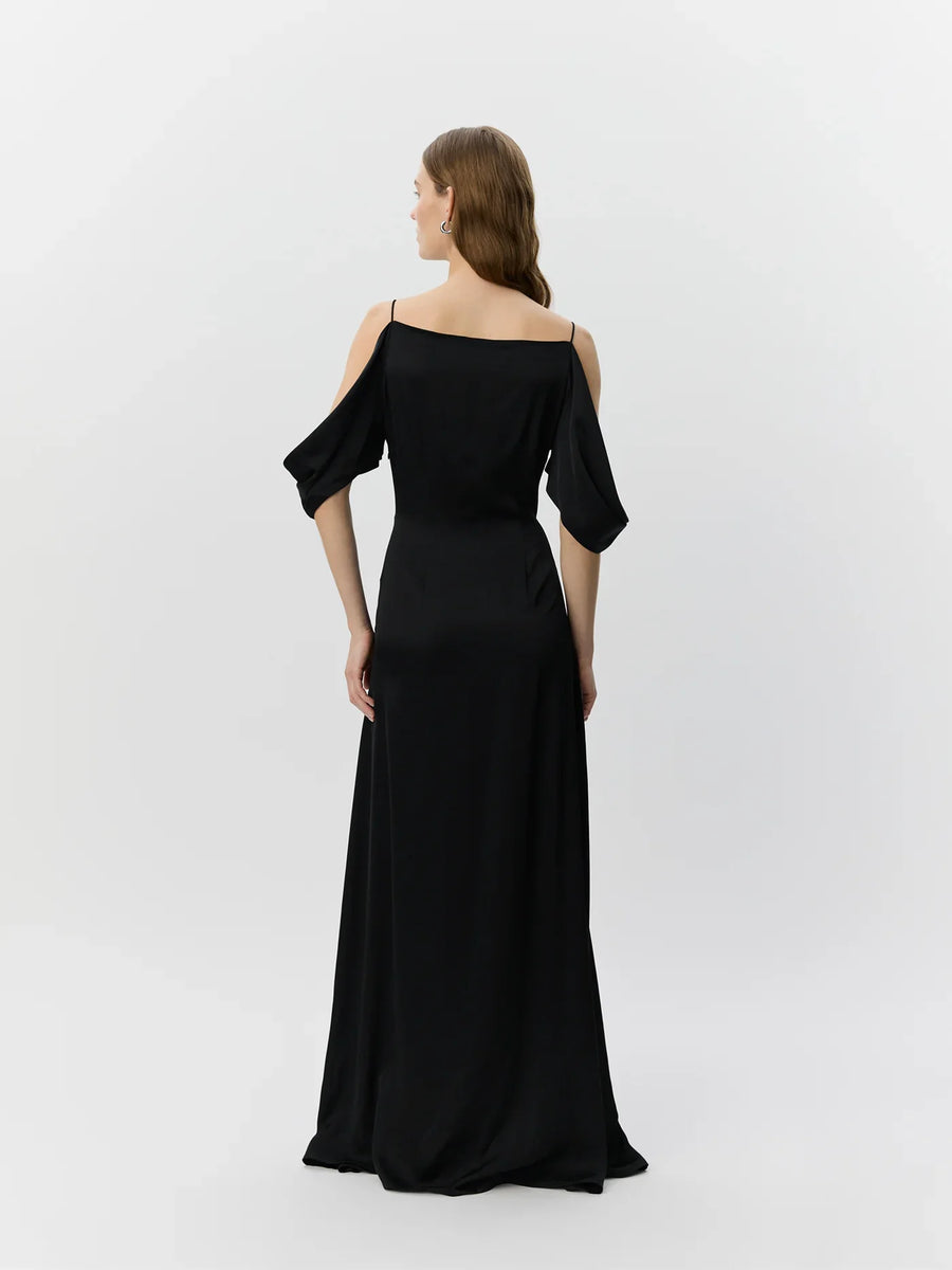 Woman wearing a black off-shoulder dress on a white background