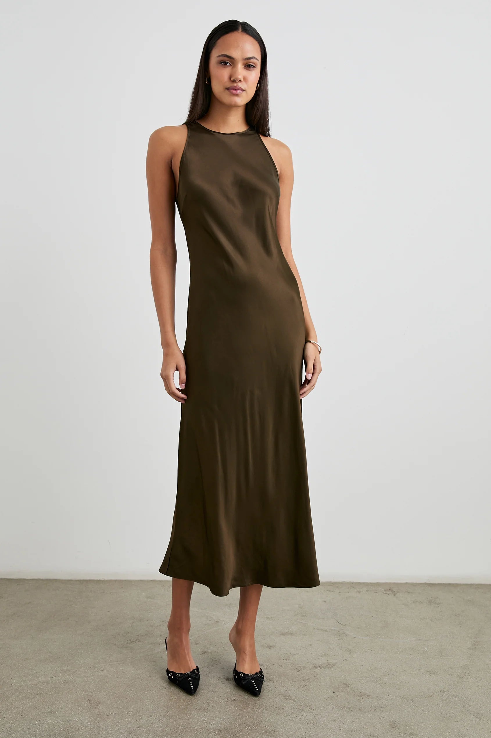  woman wearing a dark green satin dress