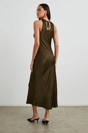 back view of a woman wearing a dark green satin dress