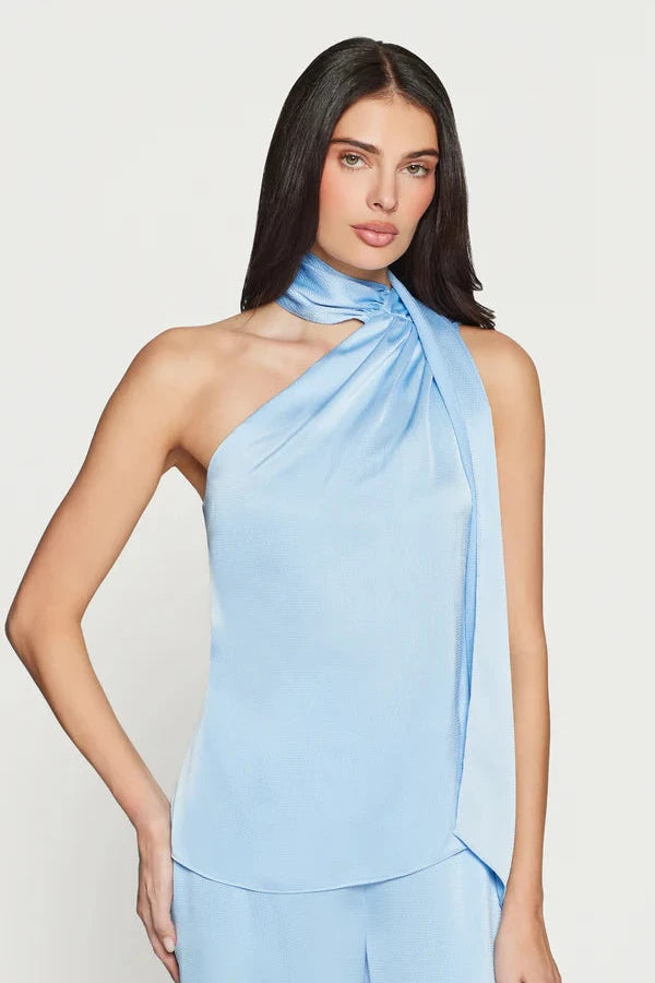 Woman wearing a light blue satin halter neck scarf blouse 