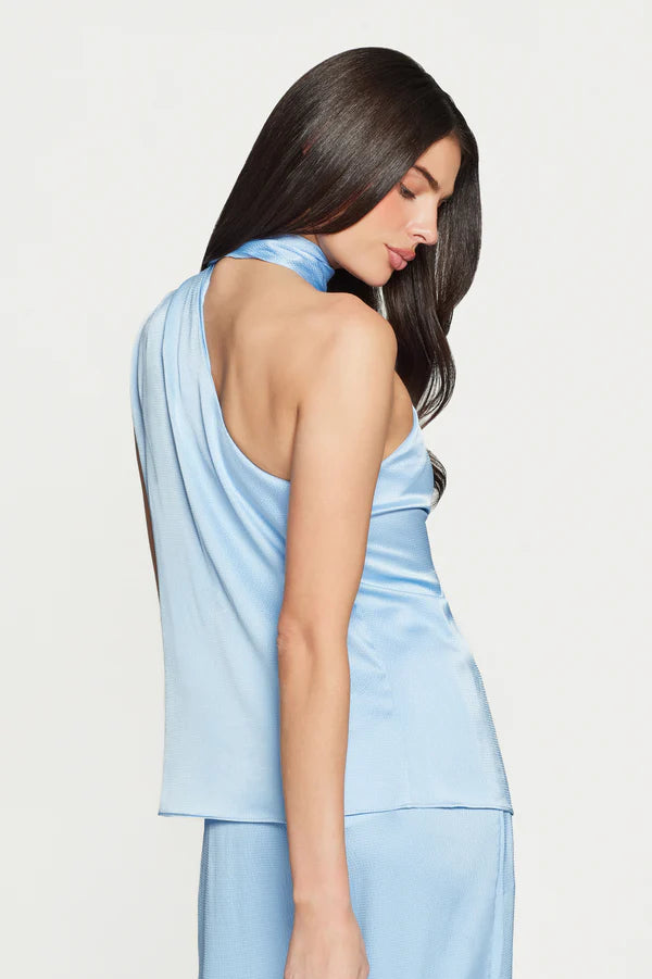Woman wearing a light blue satin halter neck scarf blouse 