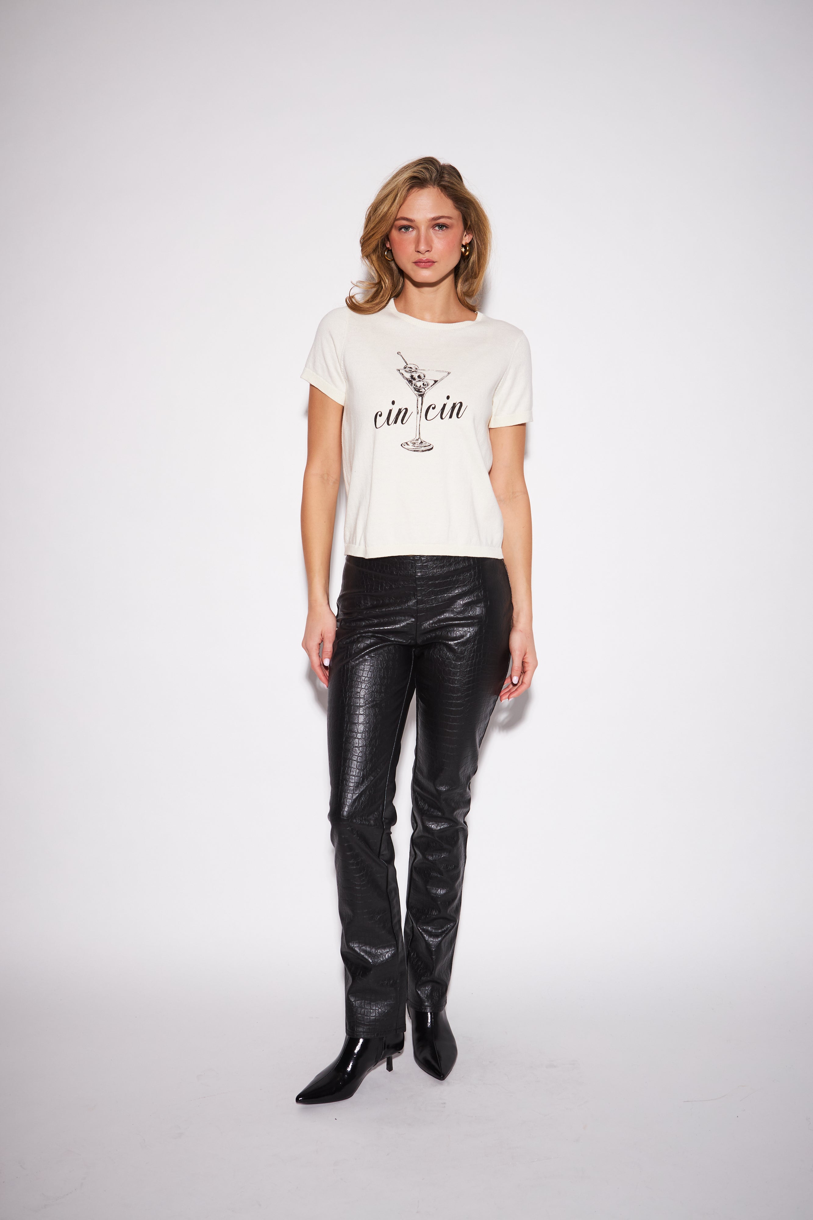 model wearing a white graphic crew neck T-shirt with black script lettering paired with black script lettering