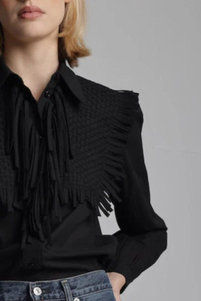 Close-up of woman wearing a black blouse with fringe details