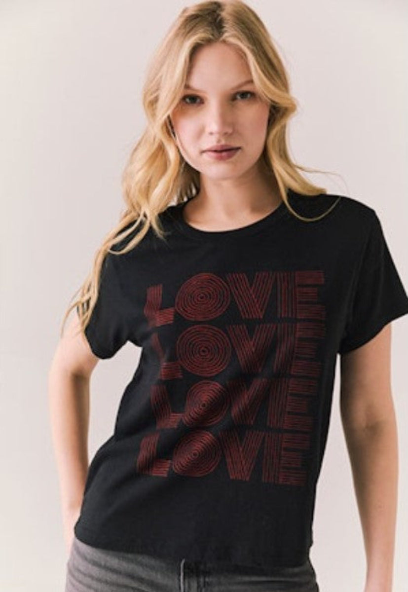 Woman wearing a black t-shirt with 'LOVE' printed in red.