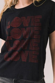 Woman wearing a black t-shirt with 'LOVE' printed in red.