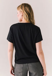 Person wearing a black t-shirt from behind on a plain background