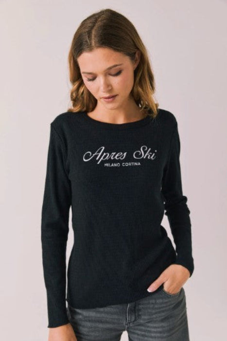 Woman wearing a black long-sleeve shirt with 'Apres Ski Milano Cortina' text 